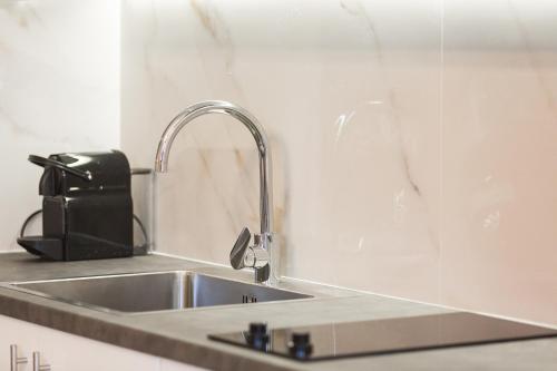 a kitchen sink with a faucet on a counter at Gorgones, sea-front, great view in Kardamyli