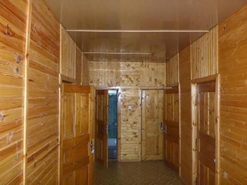 an empty room with wooden walls and doors at Ksenia pansionat in Skhidnitsa