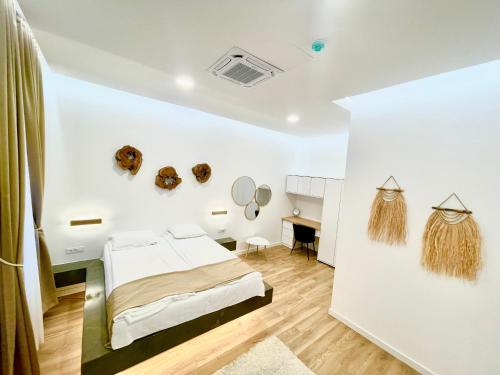 a bedroom with a bed and a desk in a room at Biosphere Lux Apartments in Sarajevo