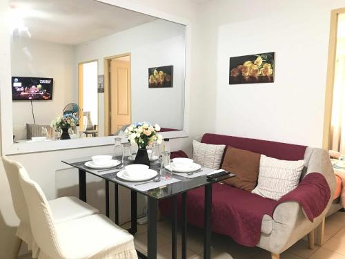 a living room with a couch and a table at MJ Luxury Living in Iloilo City