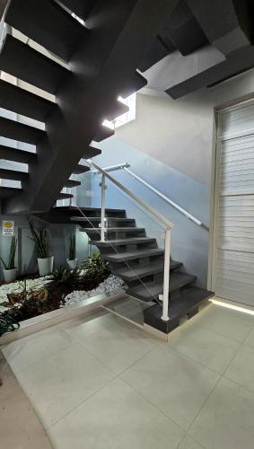 a set of stairs in a building with a stair railing at Residencial Felicita in Barueri