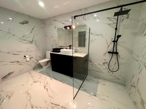 a bathroom with a shower and a sink at Tamula Lake View Apartment in Võru