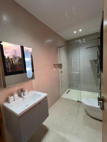 a bathroom with a sink and a toilet and a shower at Villa Dream el filali in Sraghna