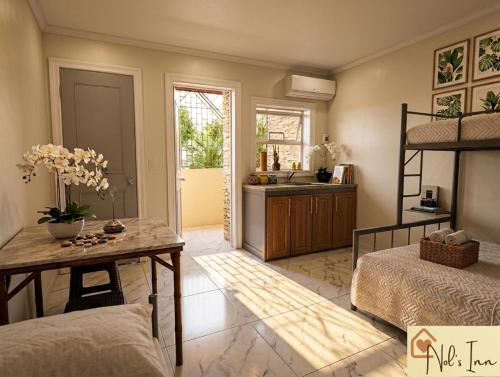 a bedroom with a bunk bed and a kitchen at Nol's Inn in Iloilo City