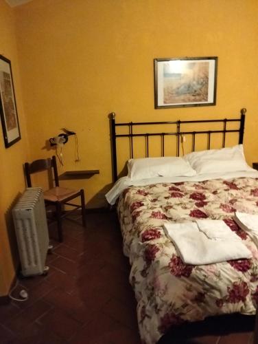 a bedroom with a bed and a table and a chair at Appartamento Margherita in Montale