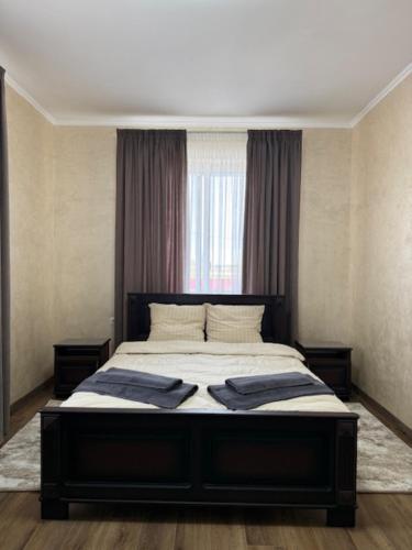 a bedroom with a bed with two towels on it at Готель-ресторан Октан in Holovanivs'k