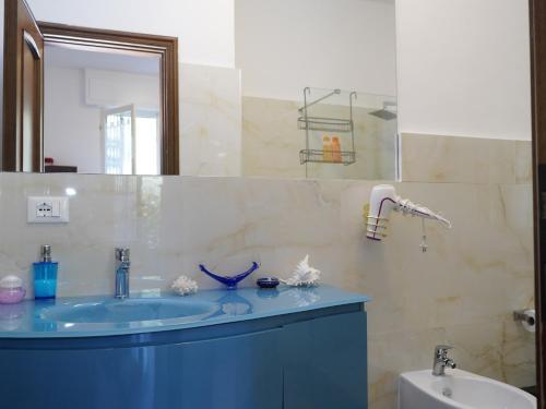 a bathroom with a blue sink and a mirror at Villa Maremonti - con 3 piscine in Sestri Levante