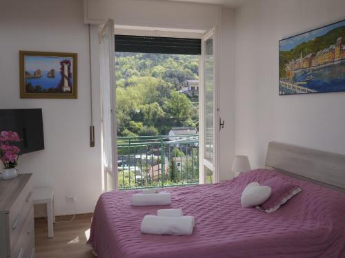 a bedroom with a purple bed with a large window at Villa Maremonti - con 3 piscine in Sestri Levante