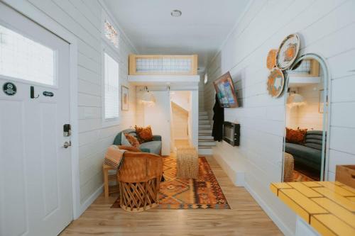 a hallway of a house with a couch and a table at The Frida Tiny House-Hot Tub-Pet Friendly-No Pet Fee! in Albuquerque