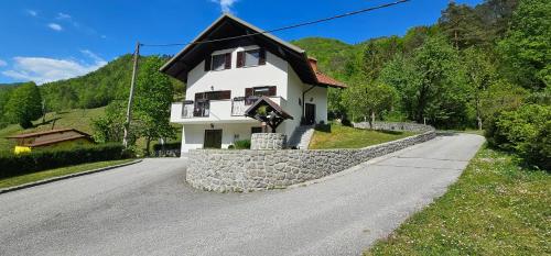 a house on the side of a road at Apartma Šmarnica in Slap ob Idrijci
