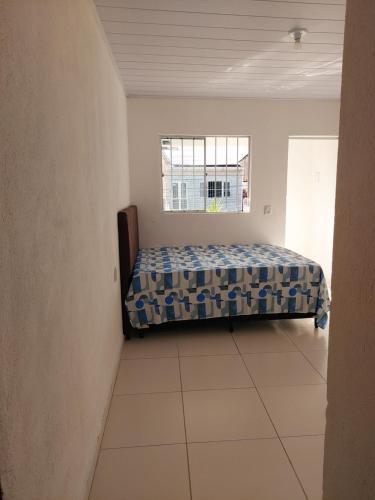 a bedroom with a bed and a window at Angelsuites in Maceió