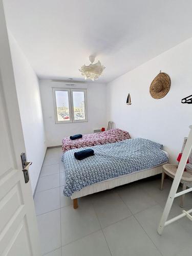 a bedroom with a bed and a chair in it at Les Sables 4 in Fort-Mahon-Plage