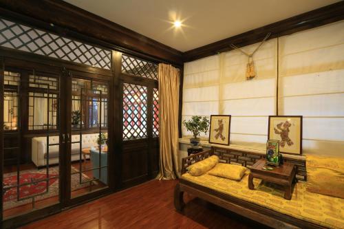 a living room with a couch and a table at The Great Wall Courtyard Hostel in Yanqing