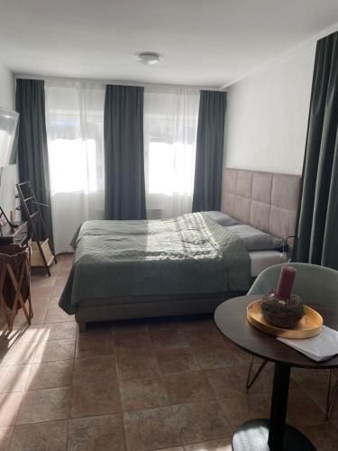 a bedroom with a bed and a table with a bowl on it at Quartier am Fluss - CityNest in Innsbruck