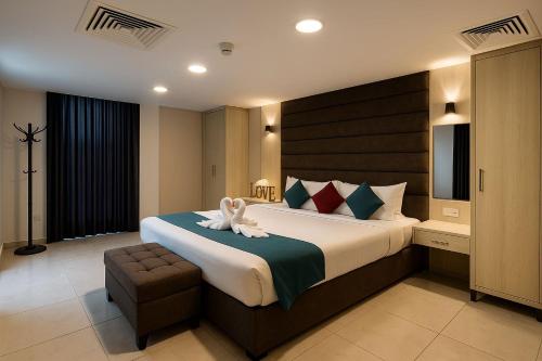 a bedroom with a large bed with a rabbit on it at Al Amer Palace Hotel in Amman