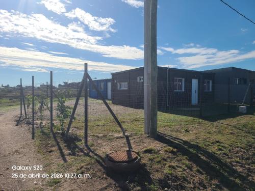 a row of poles in a yard next to a pole at Refugio del Horizonte Colonia in Colonia del Sacramento