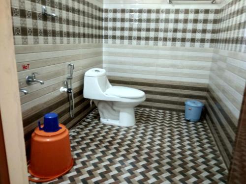 a bathroom with a toilet in a shower stall at Adhivilla resort in Thirunelli