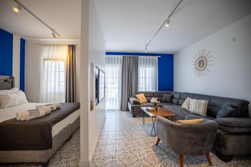 a living room with a couch and a bed at Noa Suite Hotel Only Adult in Bodrum City