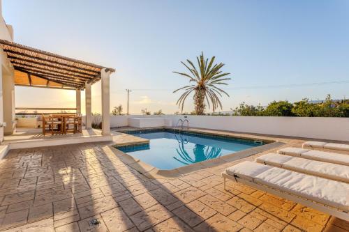 a villa with a swimming pool and a patio at Villa Enalia Paphos in Paphos