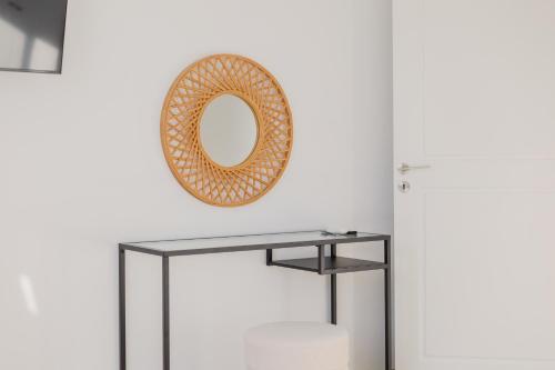 a mirror on a wall next to a table at Nireas Villa in Paphos