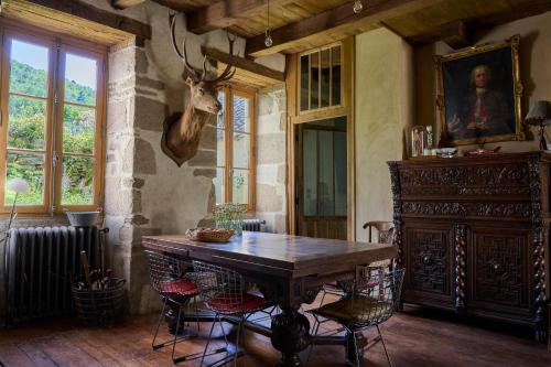 a dining room with a wooden table and chairs at Castel de Grafeuille in Hautefage