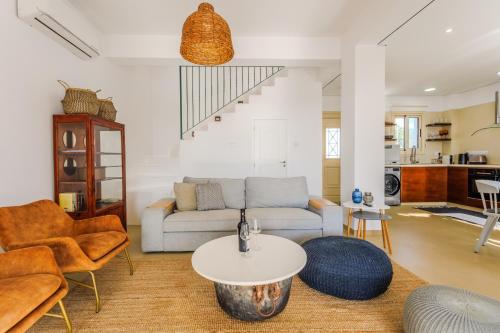 a living room with a couch and a table at Nireas Villa in Paphos