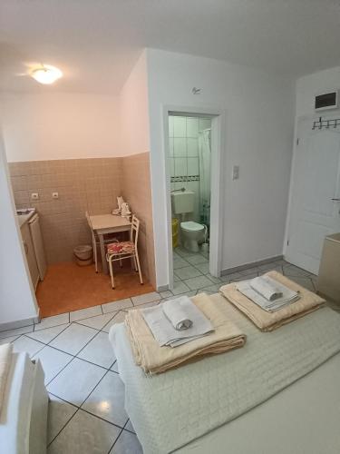 a room with a bathroom with a table and a sink at Vila Vukotić in Petrovac na Moru