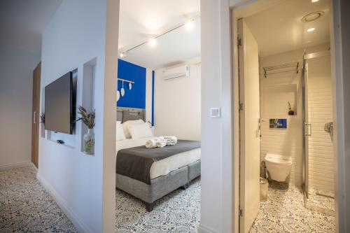 a bedroom with a bed and a bathroom with a toilet at Noa Suite Hotel Only Adult in Bodrum City
