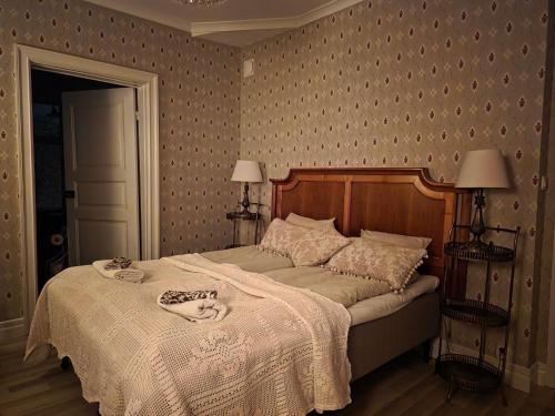 a bedroom with a large bed with a white blanket at Nordgrenska in Åmål