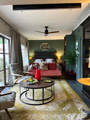 a living room with a bed and a coffee table at Greyton Stay in Greyton