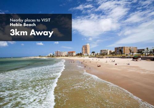 a view of a beach with people in the water at Luxury Backpackers in Port Elizabeth