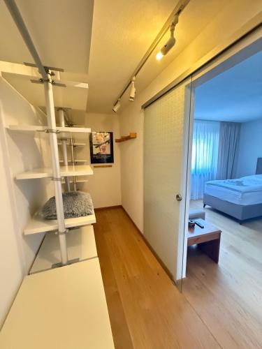 a room with white shelves and a room with a bed at Casa Emilio in Rüsselsheim