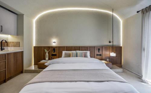 a bedroom with a large bed and a sink at DOMUS GEORGiO in Litochoro