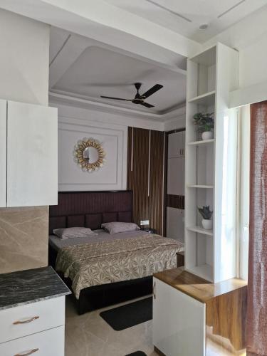 a bedroom with a bed in a room at The Happy Nook Stays in Winsten Park Knowledge Park V in Noida