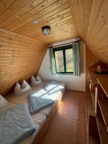 a small room with a bed and a window at Berghütte am Grenzwinkel in Sebnitz