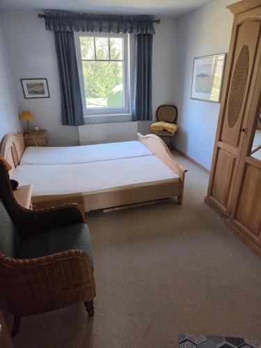 a bedroom with a large bed and a window at Ferienhaus mit Naturblick in Putbus