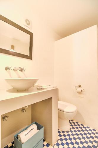 a bathroom with a sink and a toilet at Casa Porta Azul in Boliqueime