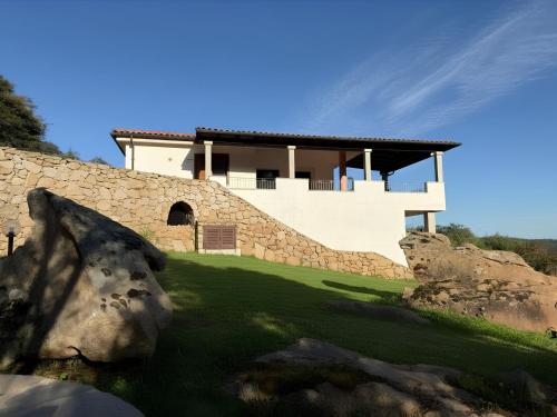 a house on top of a stone wall at Villa Olbia mare in Olbia