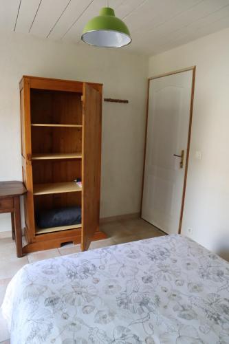 a bedroom with a bed and a closet and a door at Chambre, entrée indépendante, SDB privée in Cugand