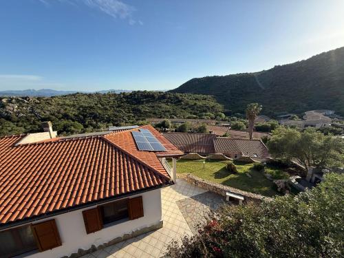 a house with a roof with solar panels on it at Villa Olbia mare in Olbia