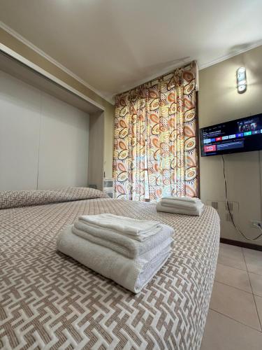 a hotel room with two beds and a large window at Chicco Light - Appartamento low cost per soggiorni brevi Vercelli Wi-Fi - Cinelli Apartment in Vercelli
