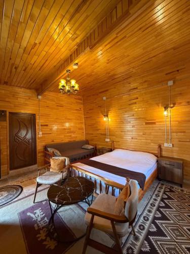 a bedroom with a large bed in a wooden room at Ela Sultan Han Otel in Gaziantep