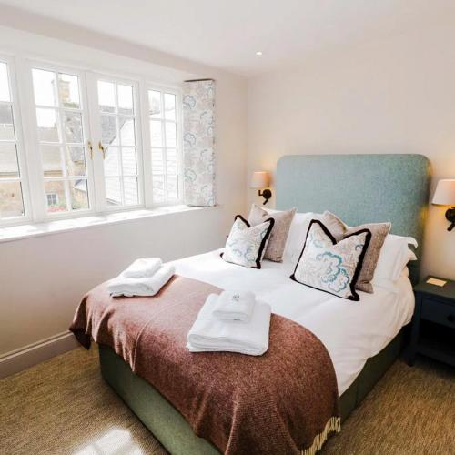 a bedroom with a bed with towels on it at Bay House in Broadway