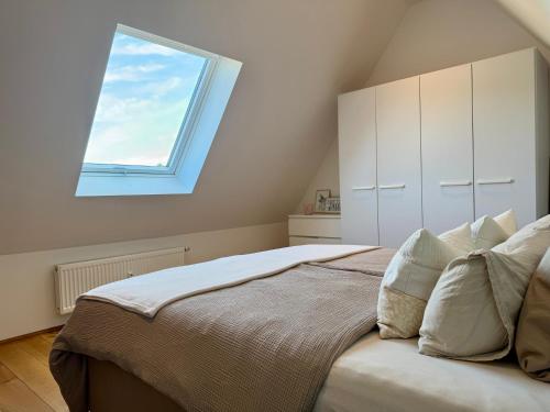 a bedroom with a large bed with a window at Wohnung Dorfblick in Hauenstein