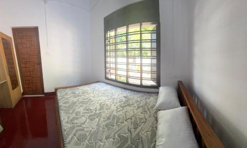 a room with a bed and a large window at Nature Heritage by Marari in Mararikulam
