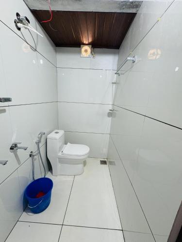 a white bathroom with a toilet and a shower at Nature Heritage by Marari in Mararikulam