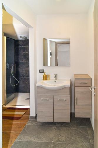 a bathroom with a sink and a shower at CáMillina in Santa Maria Maggiore