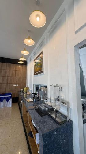 a long counter in a room with a counter top at Blessing Hotel Pandan in Halangan