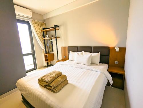 a bedroom with a large white bed with a pillow at Lovina 20-AE at One Residence in Batam Center