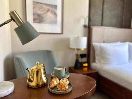a table with a tea kettle and croissants on it at The BOGUSZ Wladyslawowo in Władysławowo